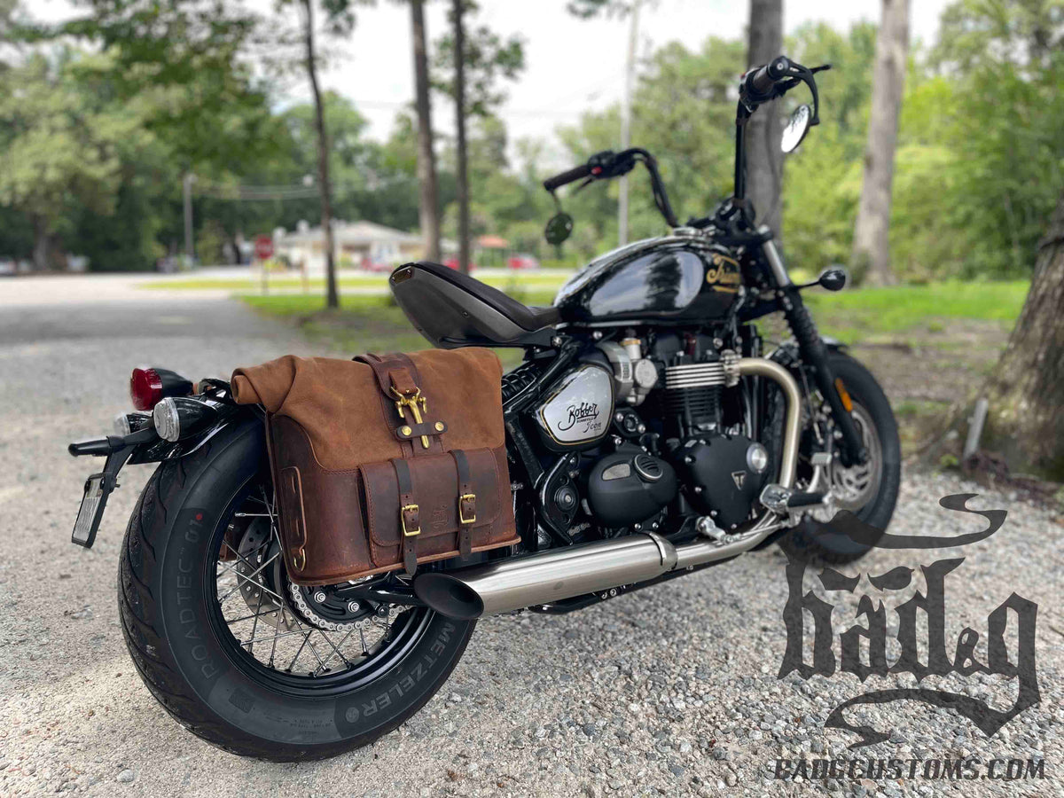 Triumph Bonneville Bobber Panniers Rolltop Swingarm Saddlebags. Hand crafted in USA with premium veg tan water buffalo leather, waterproof liners and solid brass hardware. BAD&G Customs TBP01