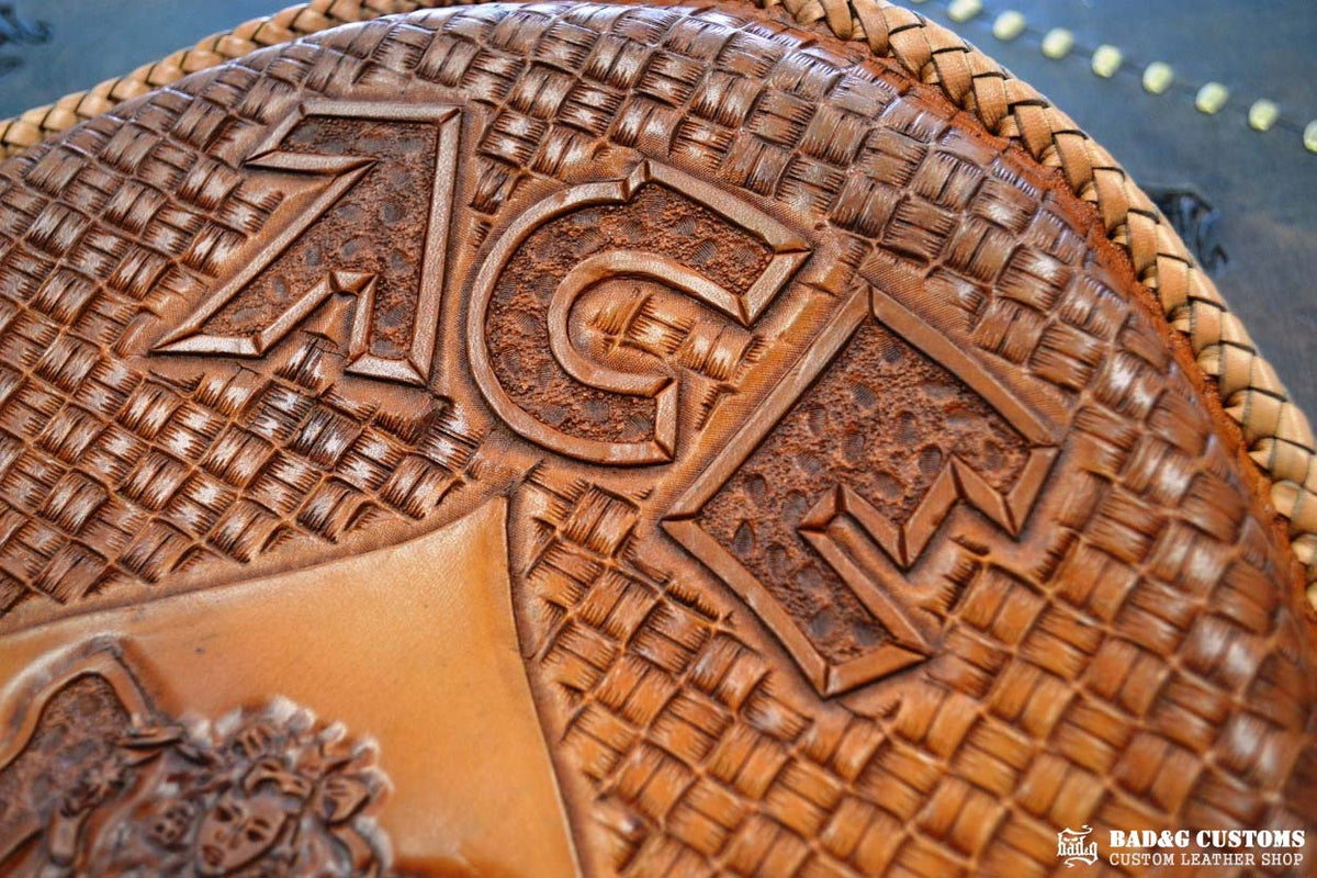 "ACE Pin-Up Girl" design hand tooled and braided on a chopper solo seat. Veg tan leather with kangaroo lace.