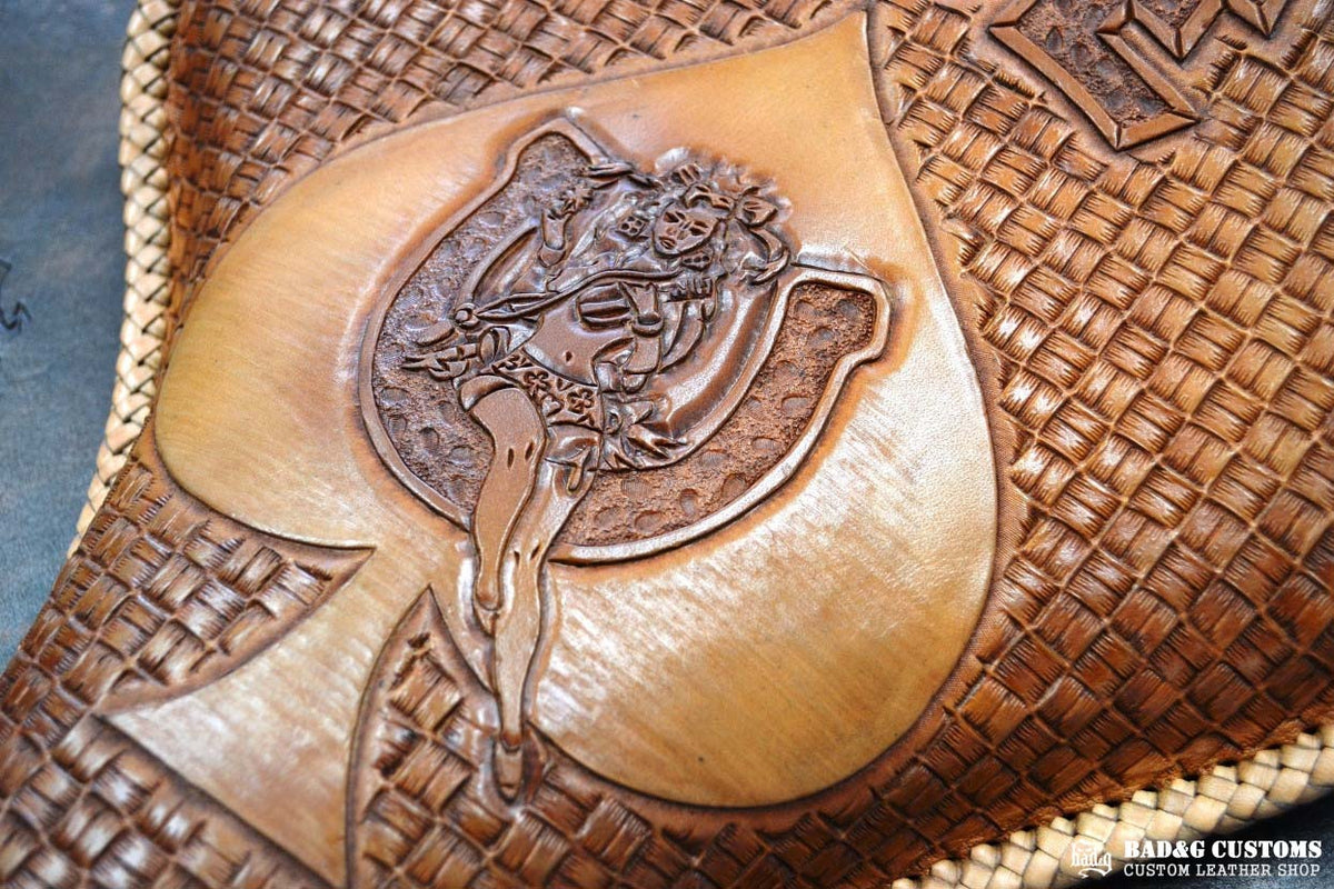 "ACE Pin-Up Girl" design hand tooled and braided on a chopper solo seat. Veg tan leather with kangaroo lace.